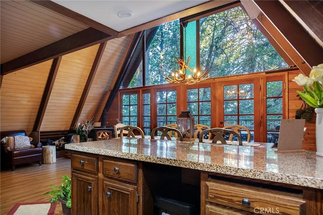 31353 Lightfoot Way, Running Springs, CA 92382 - kitchen featuring a wood stove, a chandelier, light stone countertops, wood ceiling, and wood finished floors