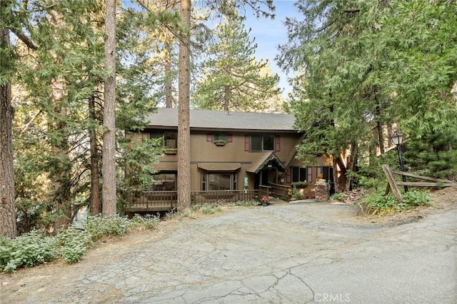 31353 Lightfoot Way, Running Springs, CA 92382 - rustic home featuring asphalt driveway and covered porch