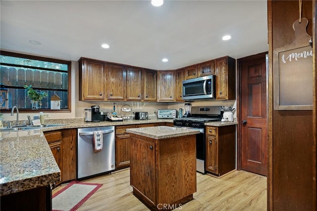31353 Lightfoot Way, Running Springs, CA 92382 - kitchen featuring appliances with stainless steel finishes, light wood-style flooring, a center island, light stone countertops, and recessed lighting