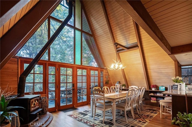 31353 Lightfoot Way, Running Springs, CA 92382 - dining room featuring a chandelier, wooden walls, french doors, beam ceiling, and wood finished floors