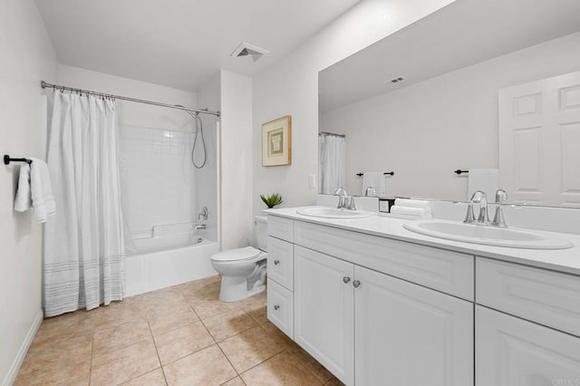 bathroom with toilet, visible vents, a sink, tile patterned floors, and double vanity