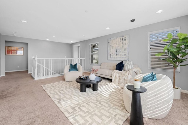 carpeted living room featuring plenty of natural light, baseboards, and recessed lighting