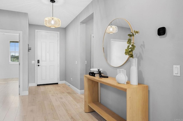 entryway with light wood-type flooring and baseboards
