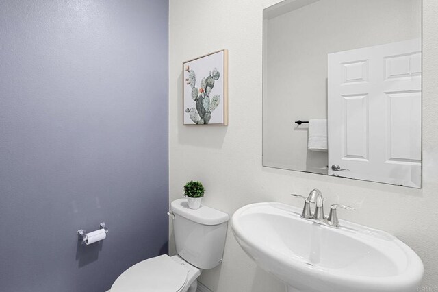 bathroom with toilet and a sink