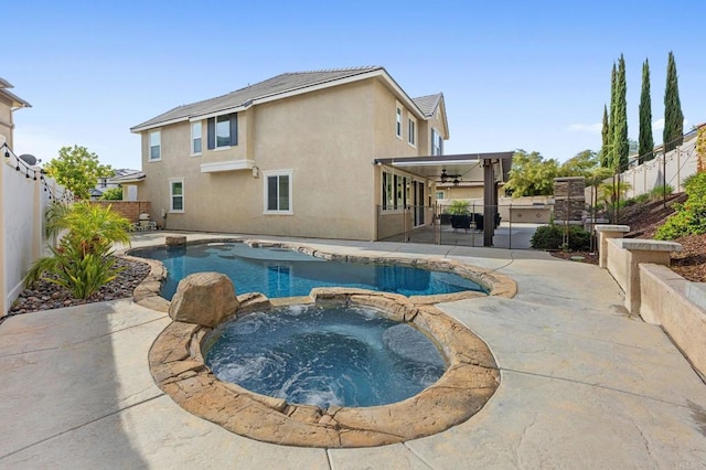 view of pool featuring a pool with connected hot tub, a patio, and a fenced backyard