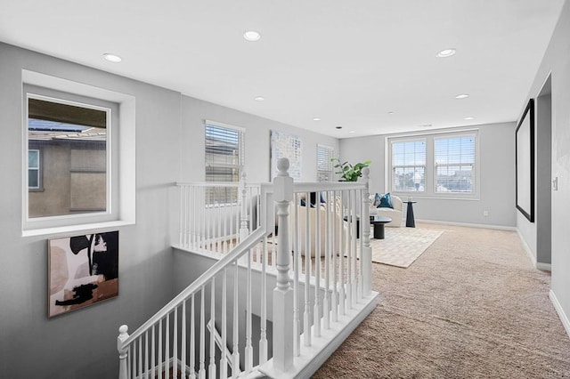 hallway featuring baseboards, an upstairs landing, recessed lighting, and carpet floors