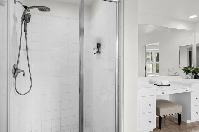 bathroom featuring a stall shower, tile patterned floors, and vanity