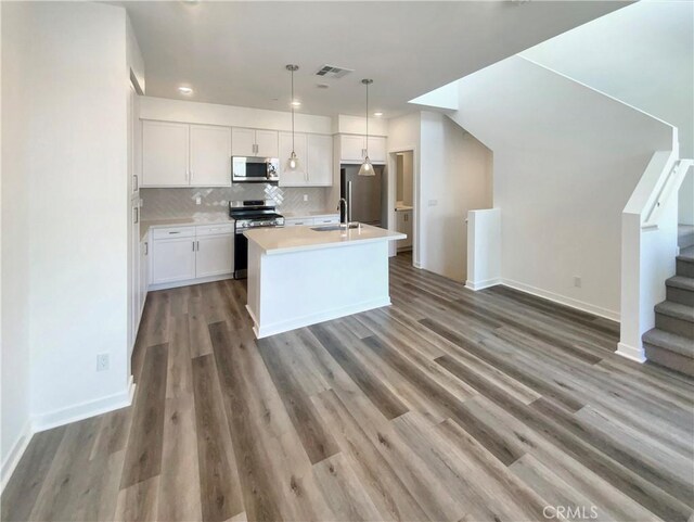 11032 Momentum Dr, Rancho Cucamonga, CA 91730 - kitchen featuring stainless steel appliances, visible vents, white cabinetry, and a sink
