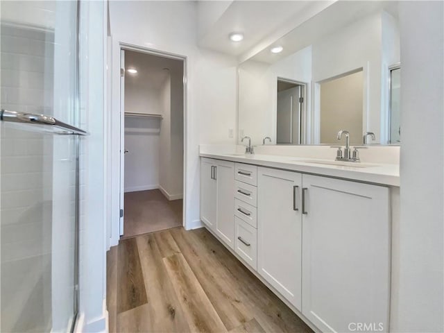 11032 Momentum Dr, Rancho Cucamonga, CA 91730 - bathroom featuring a shower stall, recessed lighting, and a sink