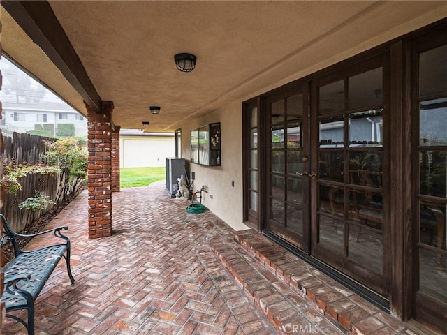view of patio / terrace featuring french doors and fence