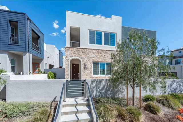 contemporary home with stucco siding and stone siding