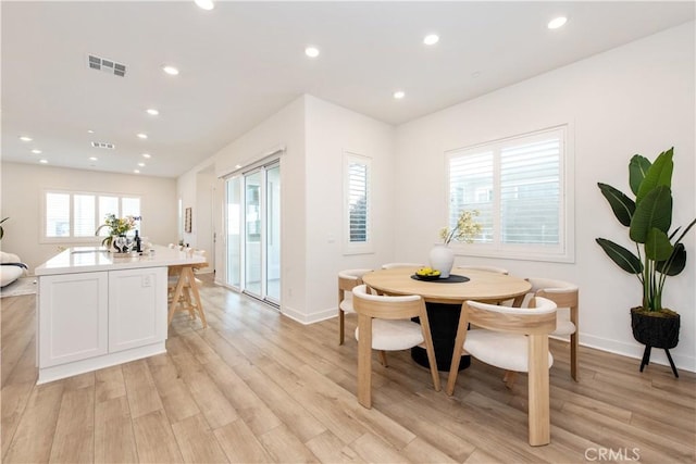 dining area with recessed lighting, light wood finished floors, and visible vents