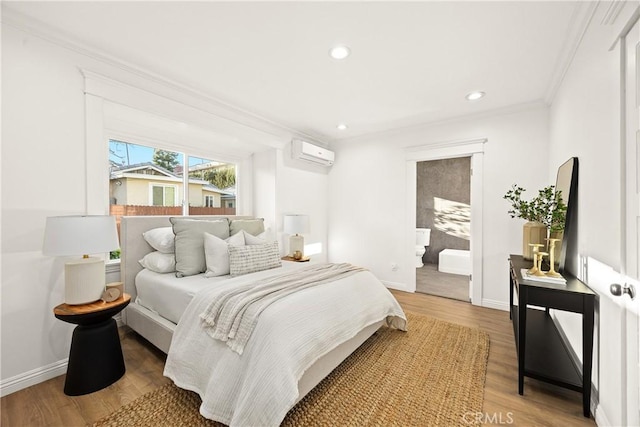 bedroom with light wood finished floors, baseboards, a wall mounted AC, and crown molding