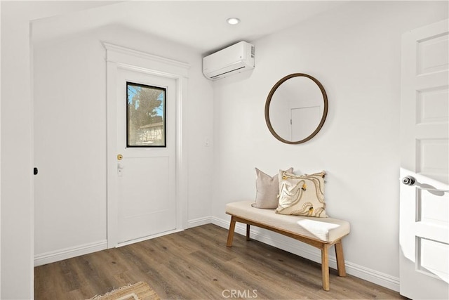 doorway featuring a wall mounted air conditioner, baseboards, wood finished floors, and recessed lighting