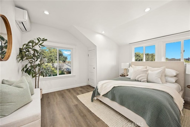 bedroom with a wall mounted air conditioner, lofted ceiling, multiple windows, and wood finished floors