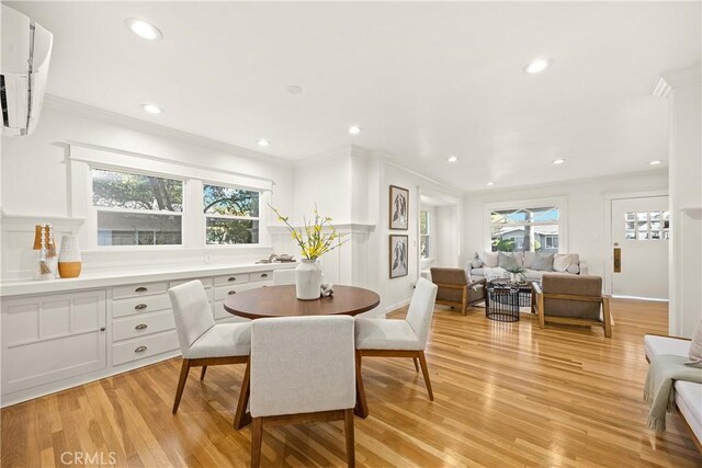 dining room with light wood finished floors, recessed lighting, and ornamental molding