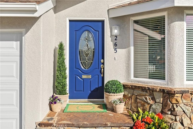 property entrance featuring stucco siding