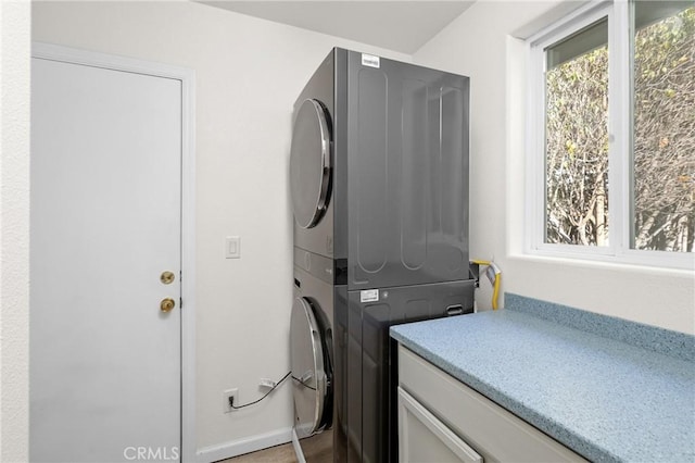 laundry room with stacked washer / drying machine
