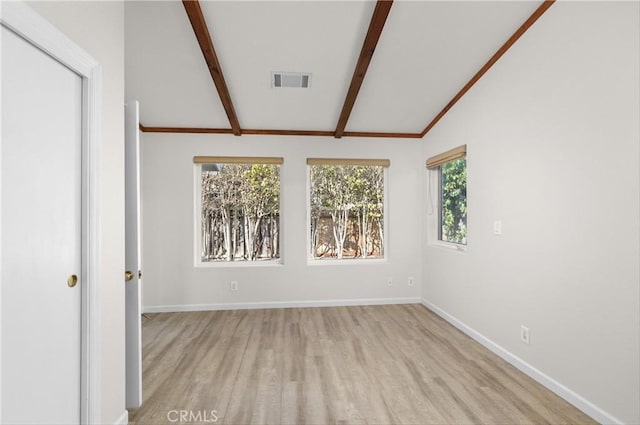 unfurnished room featuring lofted ceiling with beams, baseboards, visible vents, and light wood-style floors