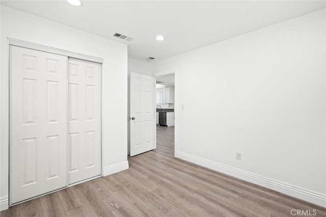 528 W 43rd St, Los Angeles, CA 90037 - unfurnished bedroom featuring wood finished floors, recessed lighting, and a closet