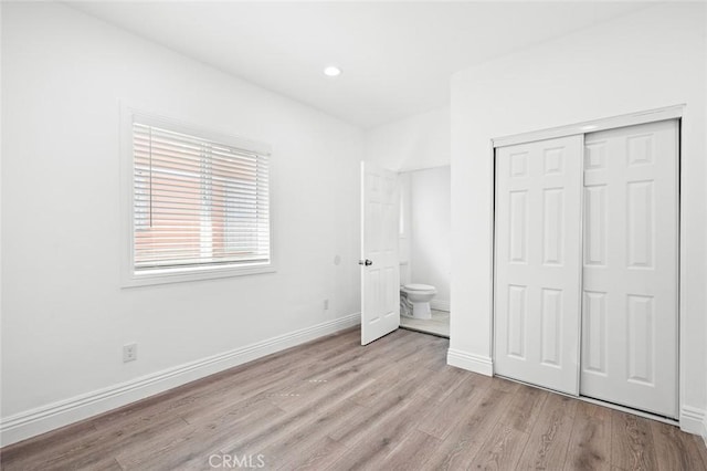 528 W 43rd St, Los Angeles, CA 90037 - unfurnished bedroom with light wood-style flooring, a closet, and recessed lighting