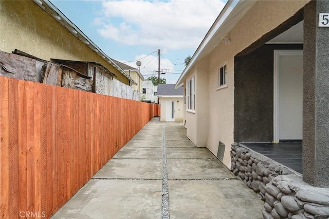 528 W 43rd St, Los Angeles, CA 90037 - view of side of home featuring stucco siding and a patio