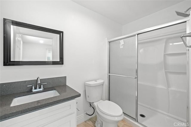 full bath featuring vanity, toilet, and a shower stall