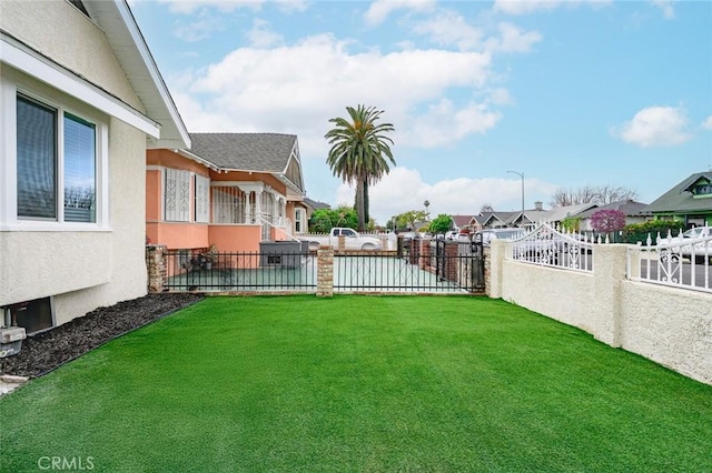 view of yard with fence and a residential view
