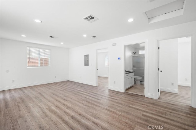 528 W 43rd St, Los Angeles, CA 90037 - unfurnished room with electric panel, light wood-style flooring, attic access, and recessed lighting