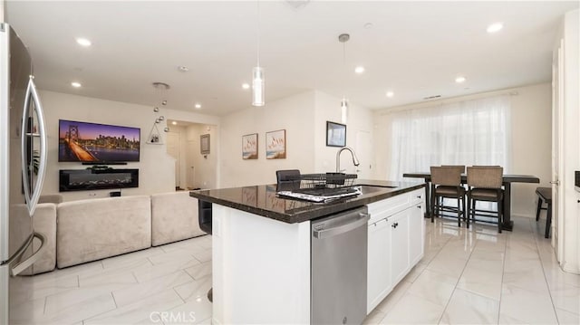 16763 Stags Leap Ln, Fontana, CA 92336 - kitchen featuring stainless steel appliances, light marble finish flooring, open floor plan, white cabinets, and recessed lighting