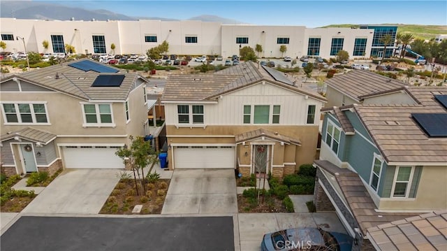 16763 Stags Leap Ln, Fontana, CA 92336 - townhome / multi-family property featuring driveway, a garage, a residential view, and stucco siding