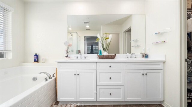 16763 Stags Leap Ln, Fontana, CA 92336 - bathroom with double vanity, a bath, and a shower stall
