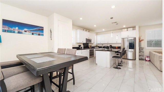 16763 Stags Leap Ln, Fontana, CA 92336 - dining room featuring light marble finish floors and recessed lighting