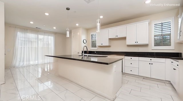16763 Stags Leap Ln, Fontana, CA 92336 - kitchen featuring light marble finish floors, a center island with sink, white cabinetry, recessed lighting, and dark countertops