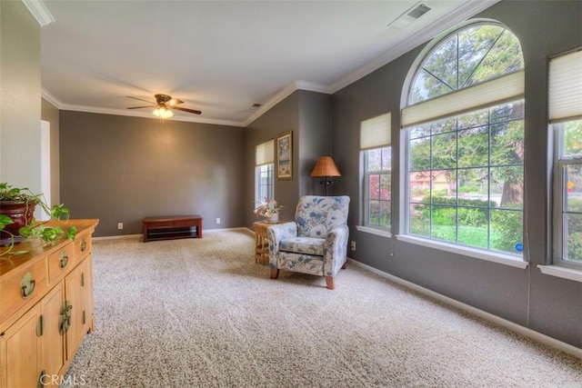 sitting room with a wealth of natural light, visible vents, and carpet floors