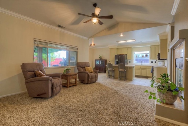 living room with vaulted ceiling, crown molding, ceiling fan, light colored carpet, and visible vents