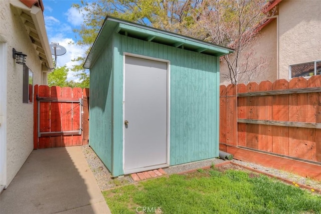 view of shed featuring fence