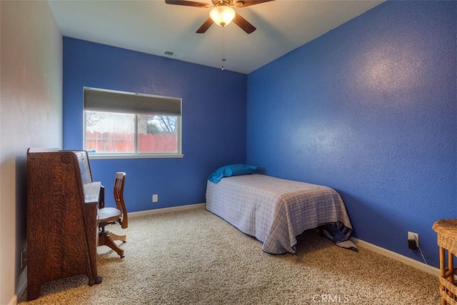 bedroom featuring baseboards, a ceiling fan, visible vents, and carpet floors