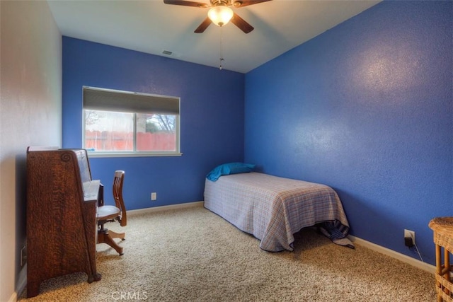 bedroom with visible vents, baseboards, a ceiling fan, and carpet