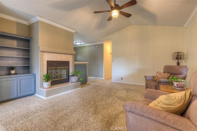 carpeted living area with ornamental molding, baseboards, a ceiling fan, and a fireplace