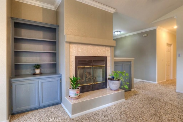 unfurnished living room with baseboards, ornamental molding, a tile fireplace, and carpet