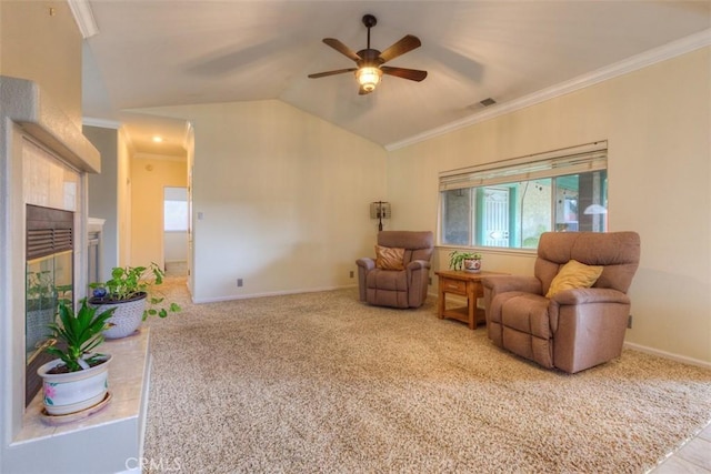 living area with vaulted ceiling, a ceiling fan, crown molding, and visible vents