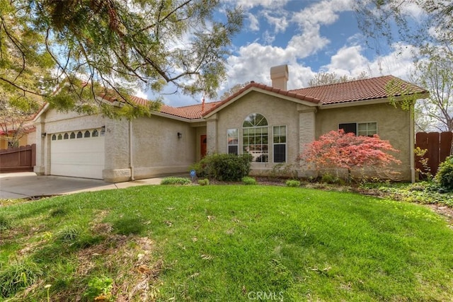mediterranean / spanish-style house with a chimney, fence, a tiled roof, stucco siding, and a garage