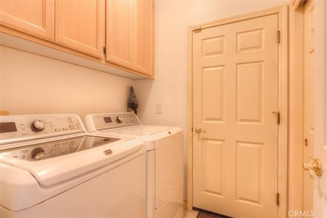 laundry area featuring cabinet space and washing machine and clothes dryer