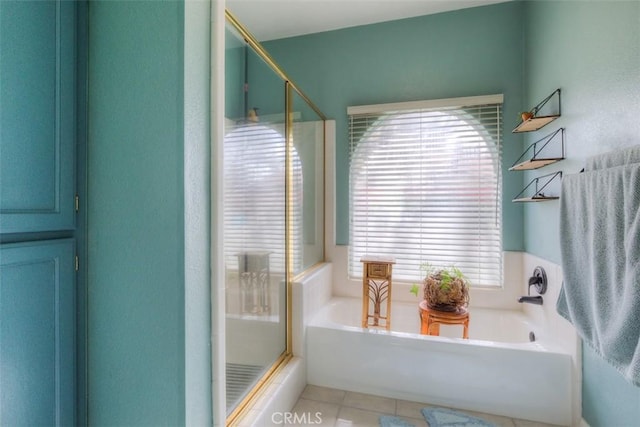 bathroom featuring a stall shower, a garden tub, plenty of natural light, and tile patterned floors