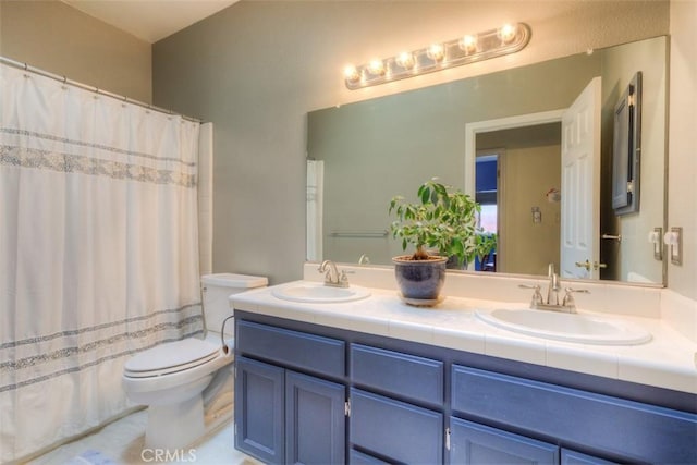 bathroom with a shower with curtain, double vanity, toilet, and a sink
