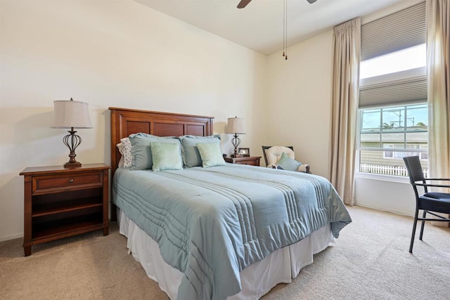 bedroom with light carpet, baseboards, and ceiling fan