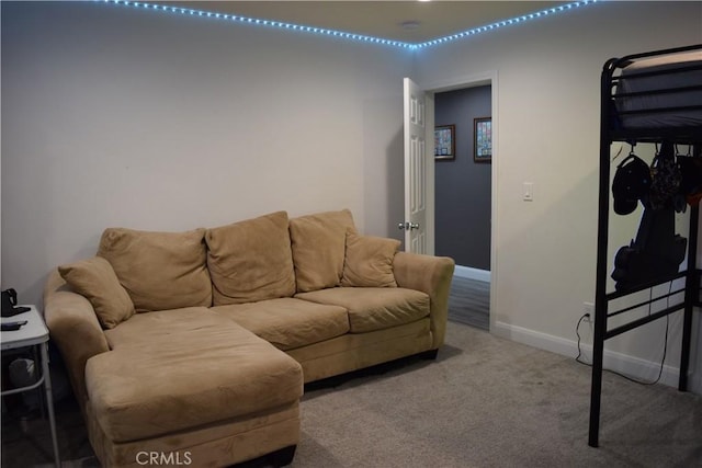 living room featuring baseboards and carpet flooring