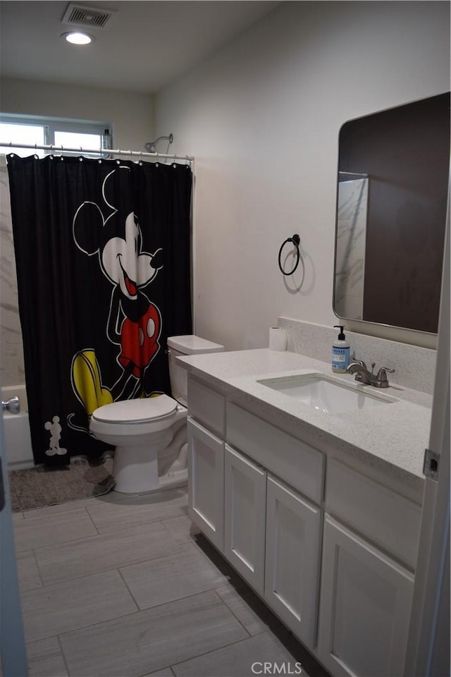 full bathroom featuring visible vents, toilet, and vanity