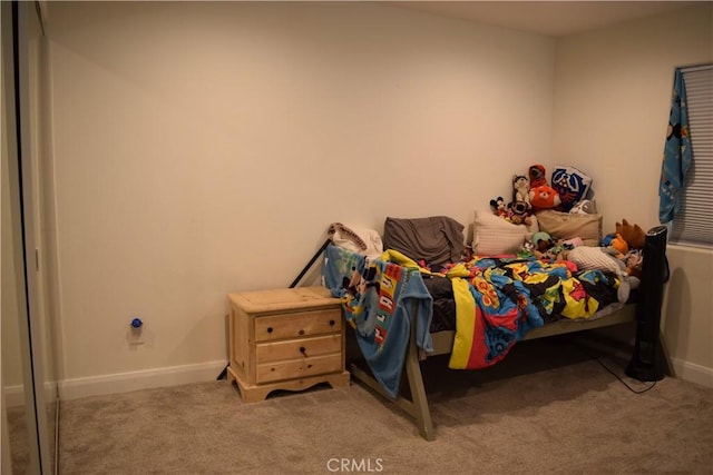 bedroom featuring baseboards and carpet flooring